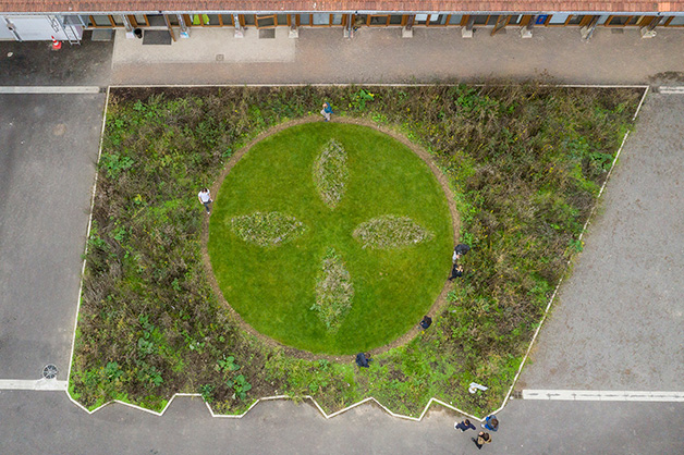 we resist. Ornamental garden by Eva-Maria Lopez, using a variety of plants that have developed resistance to herbicides sold by multi-national chemical companies. The ornament represents these companies’  logos and is reminiscent of “jardins à la française”. This artwork is seeded and planted for the exhibition OU\ /ERT. Photo; Axel Heil